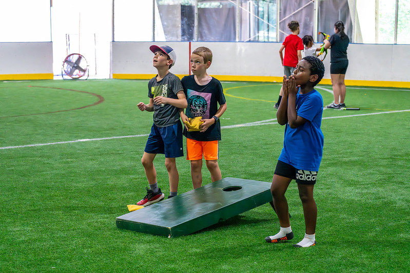 Campers playing with a beanbag toss at Week in the Park Camp.