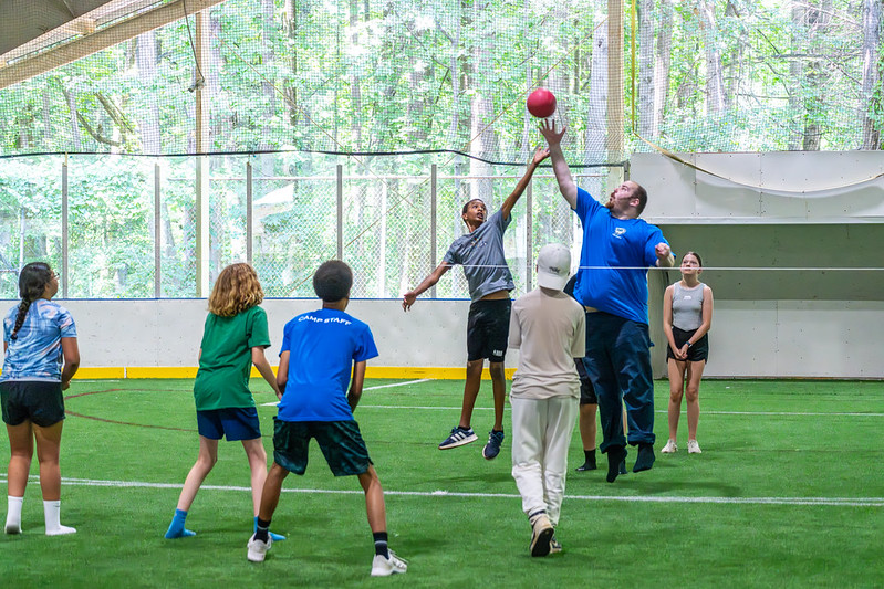 Campers playing volleyball at all sports camp
