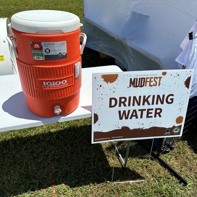 Orange water color next to a sign that reads "Drinking Water".