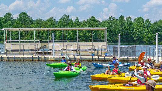 Kayaks in the foreground of pontoon boat at Black Hill