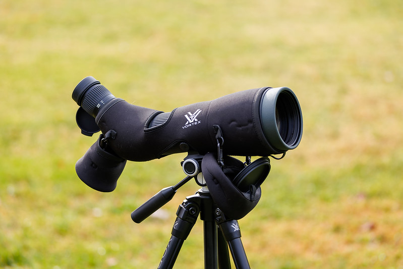 Monocular attached to tripod sitting on grass