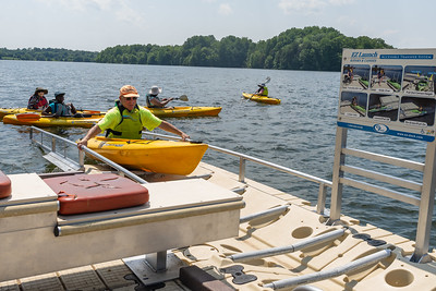 Man using handrails to loading kayak back on the accessible launch