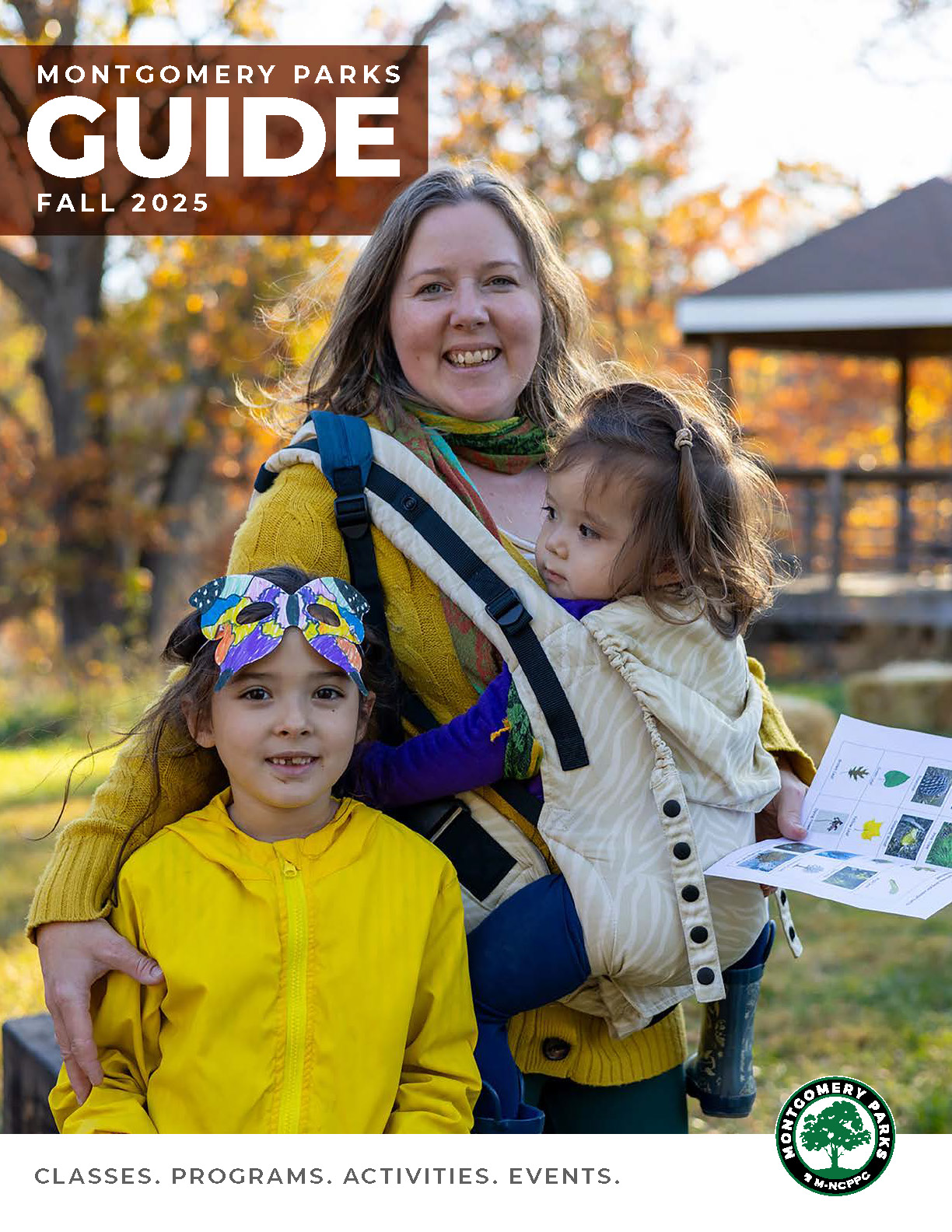 Montgomery Parks Fall Guide 2025. Classes, programs, activities and events. Adult and two children stand outdoors at a park in the fall.