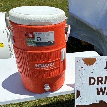Orange water color next to a sign that reads "Drinking Water".