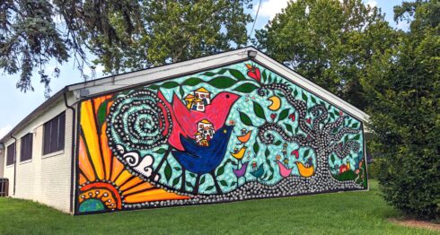 Rendering of proposed mural with whimsical birds, houses, and a tree