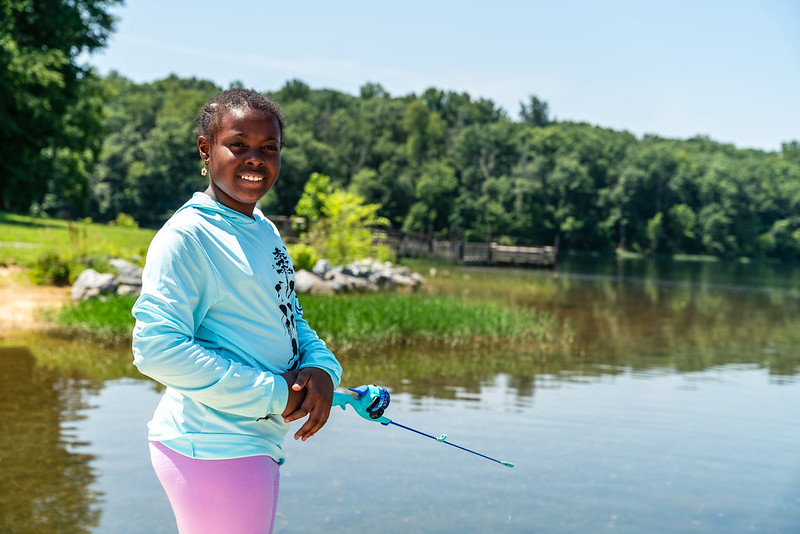 a child with a fishing pole