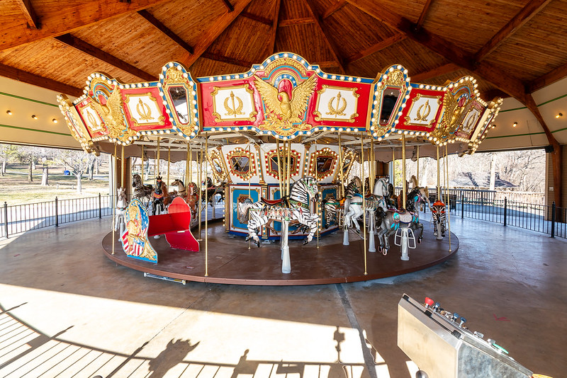 Carousel surrounded by pavement with view of ramp