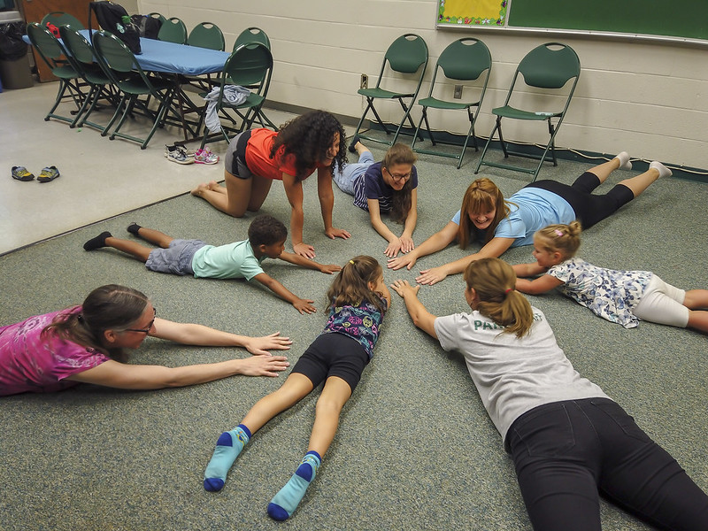 Kids laying in a circle for Yoga