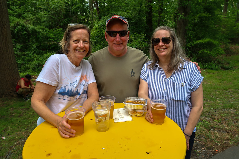 Friends smiling for camera with beers