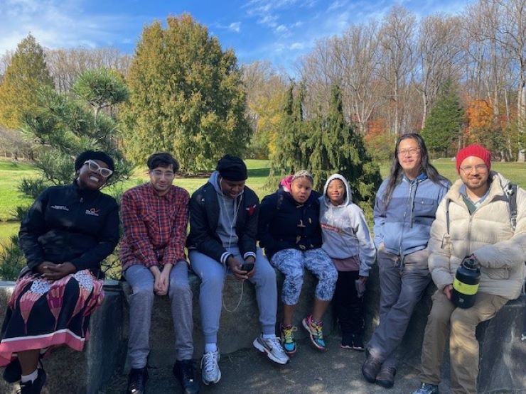 A group of Trail Trekkers participants on a bench in Brookside Gardens.