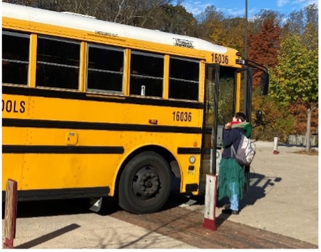 Person entering a school bus.