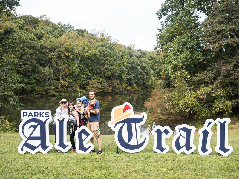 Family standing in front of large PArks Ale Trail cutouts sign.