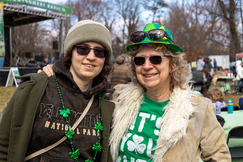 Attendees smile for camera with St Patrick's Day merch