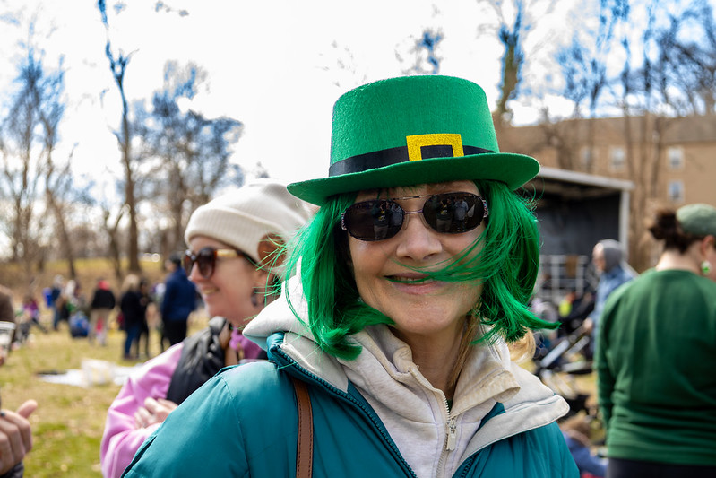 Attendee smiles with St Patrick's Day hat and green wig