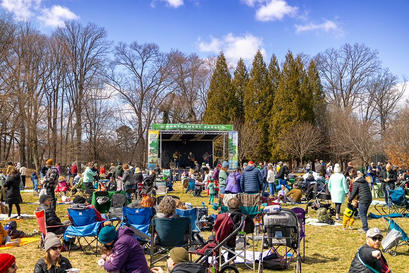 Crowd shot with large stage in background at North Four Corners Park
