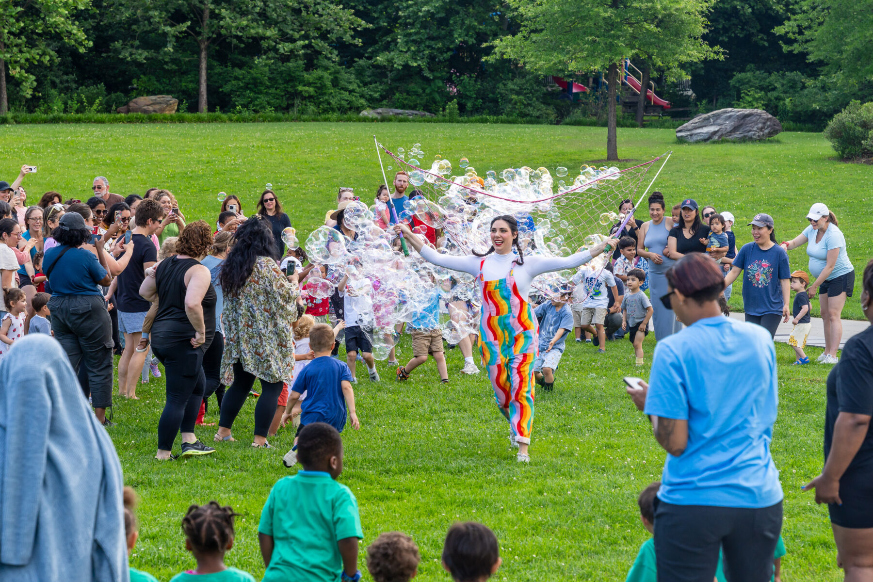Jonna Productions runs through crowd of children with giant bubble net