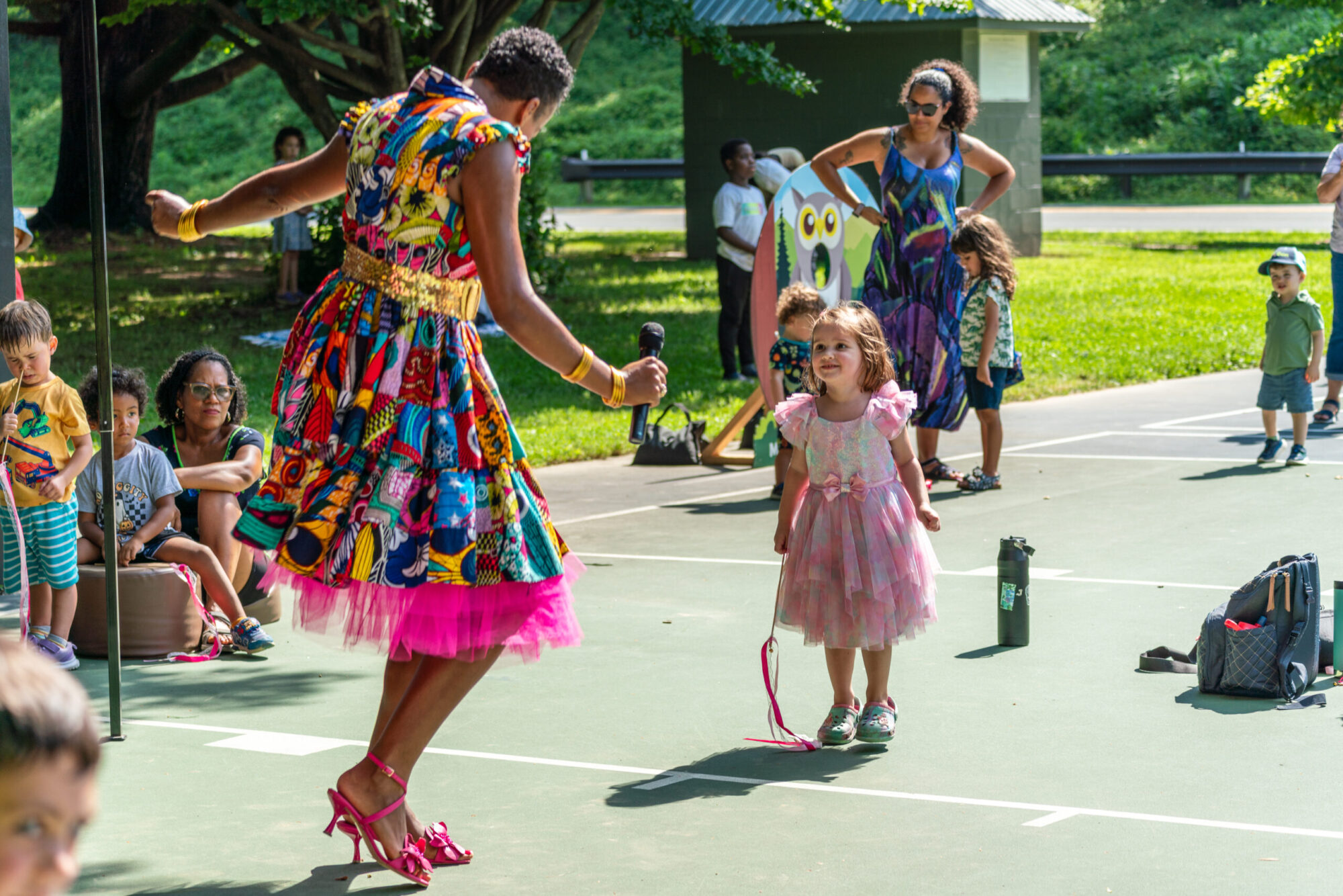 Child dances with performer, Culture Queen