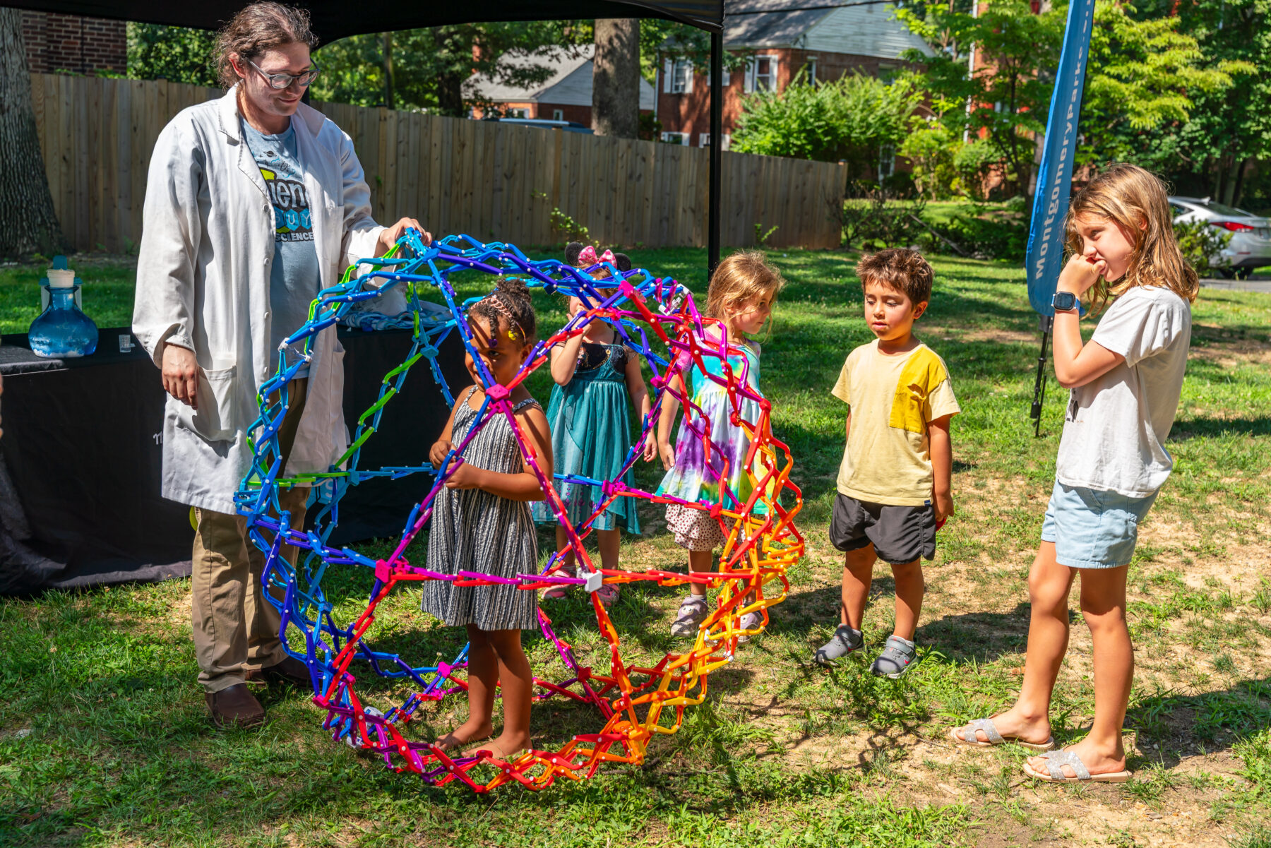 Child stands in Hoberman Sphere