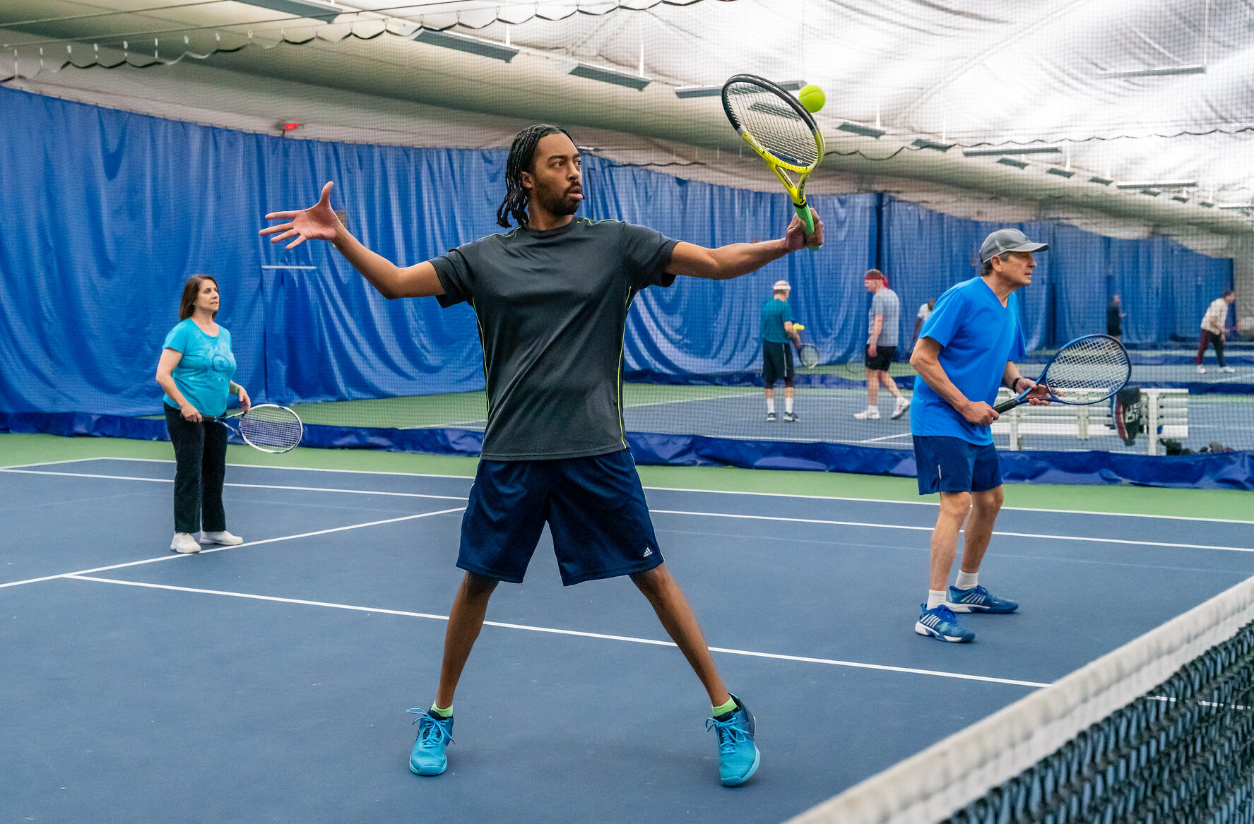 A adult playing tennis