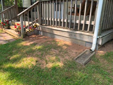 Porch with exclusion installed to exclude groundhogs