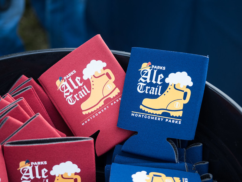 Close up shot of Parks Ale Trail red and blue koozies