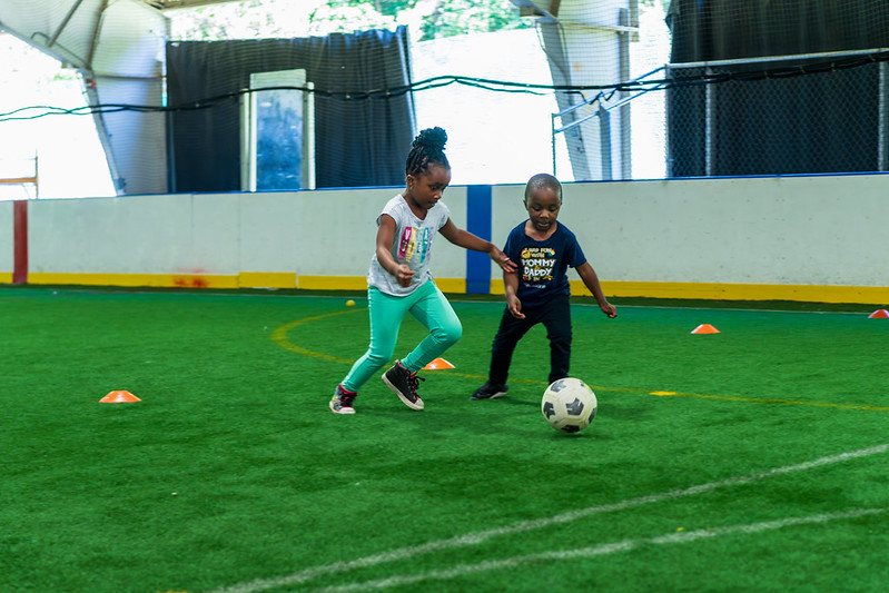 Two children playing soccer