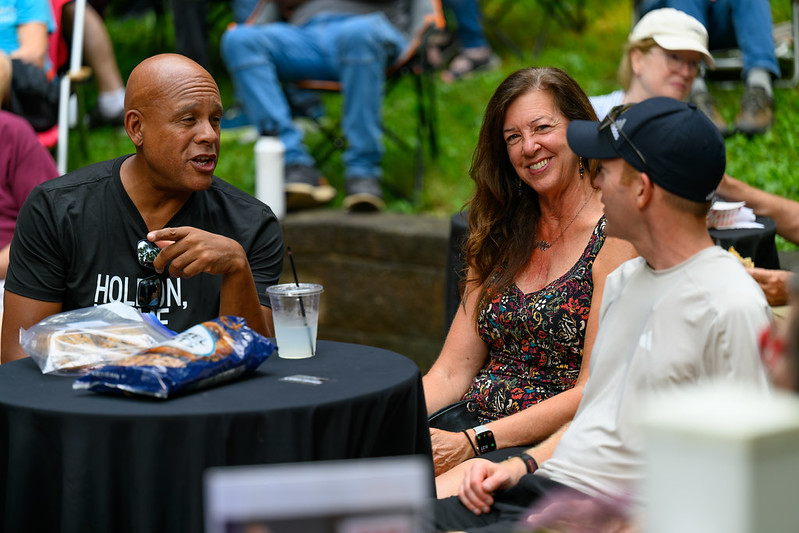 Attendees smile and talk at a table