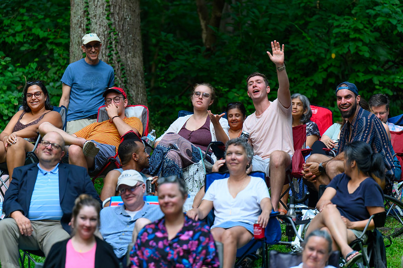Attendee in crowd raises hand