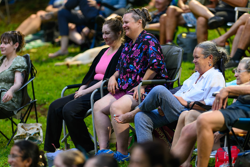 2 attendees smile while watching comedy show