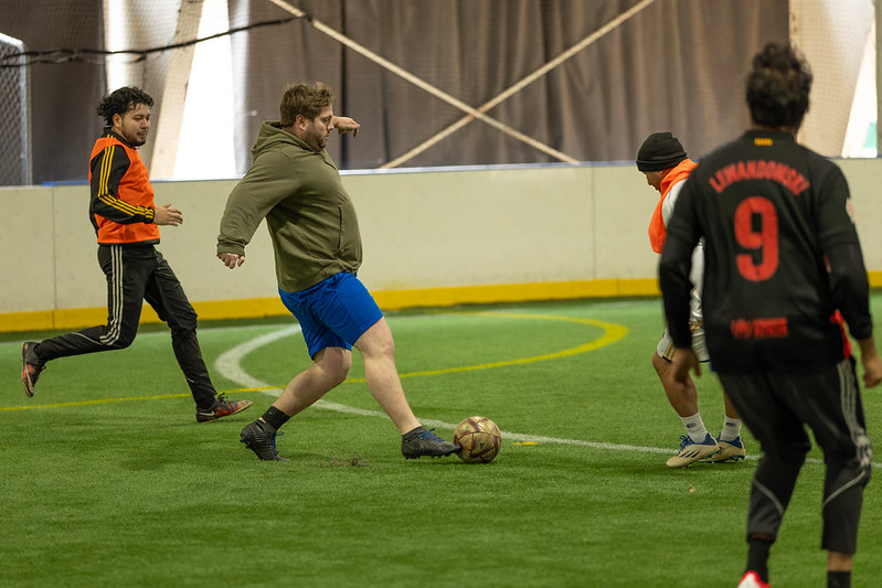 Adults playing pick up soccer