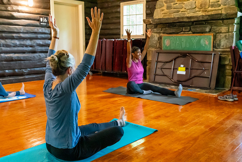 Attendees practice yoga on mats