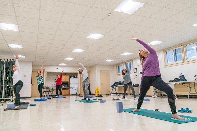 Attendees practice yoga