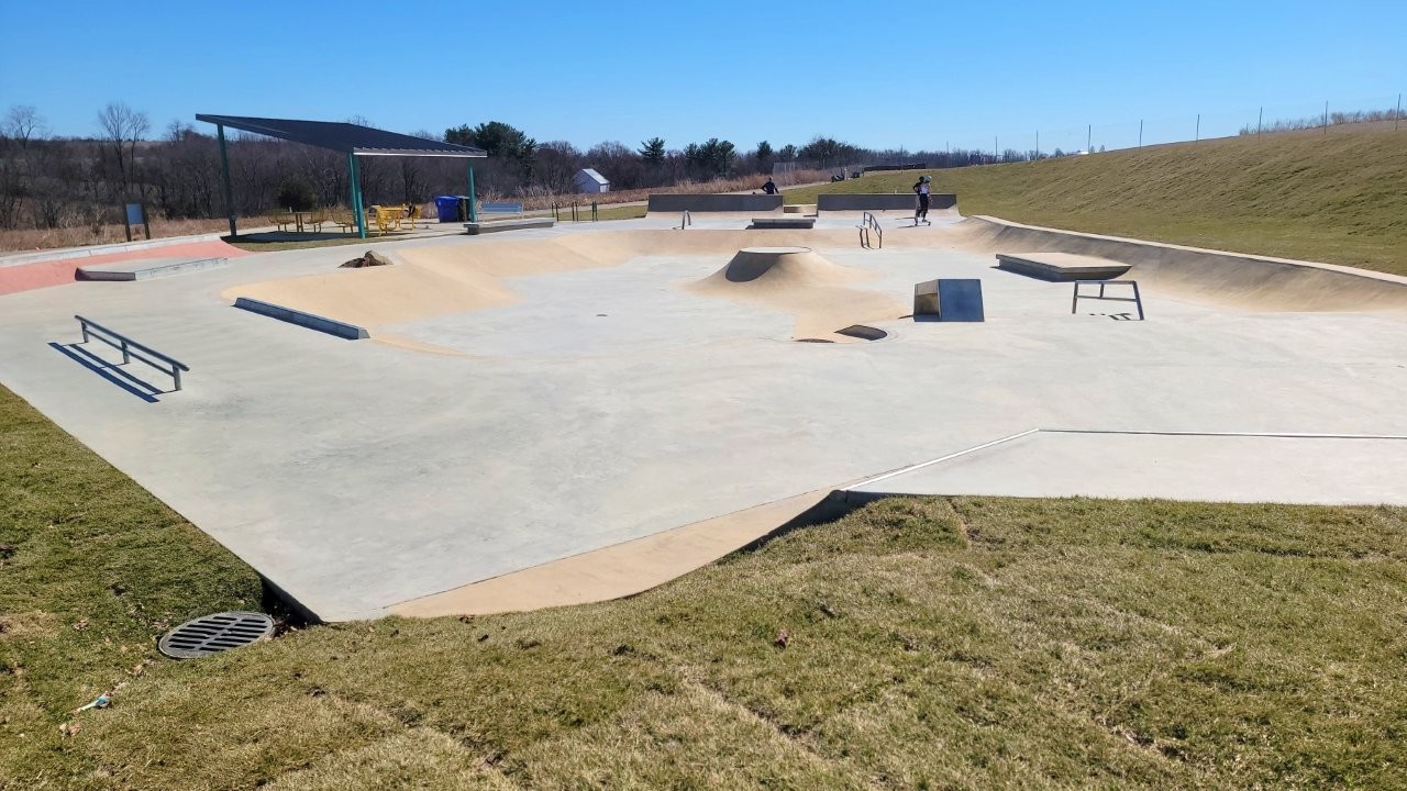 Skate park at Ovid Hazen Wells with two skaters in the background