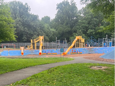 A playground with 3 large yellow slides