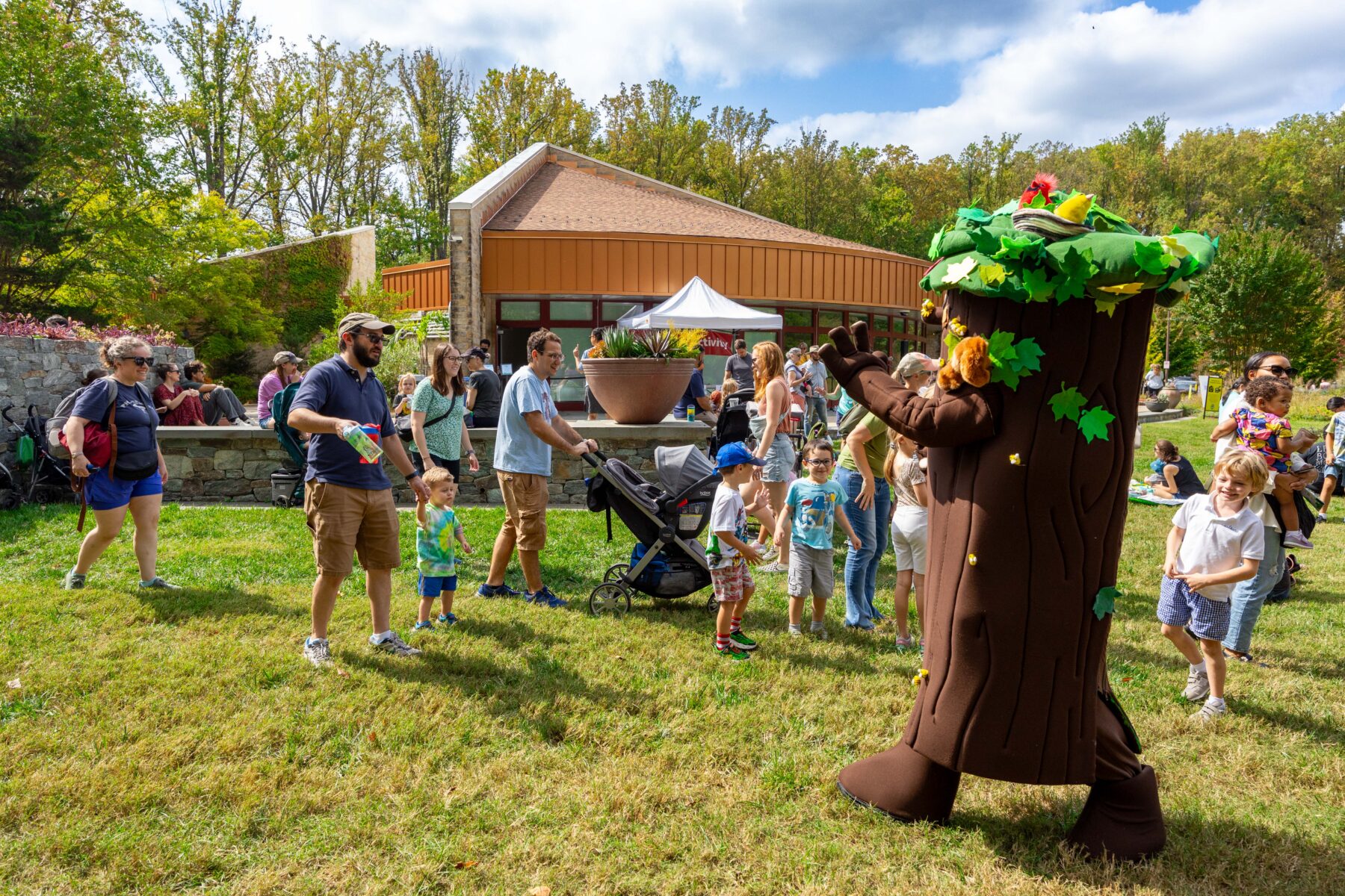 Tree mascot waving to groups of families at brookside gardens 