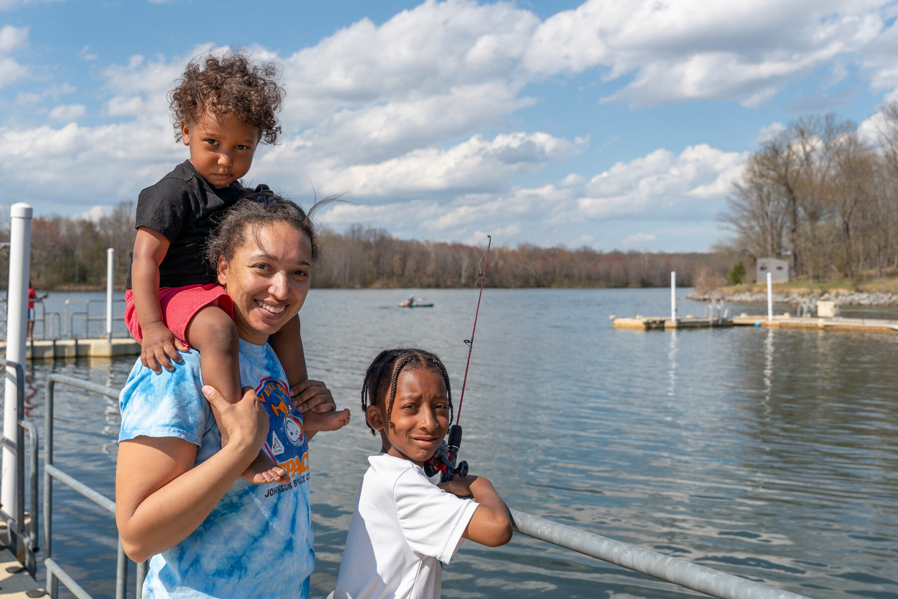 a group smiling at the camera while fishing