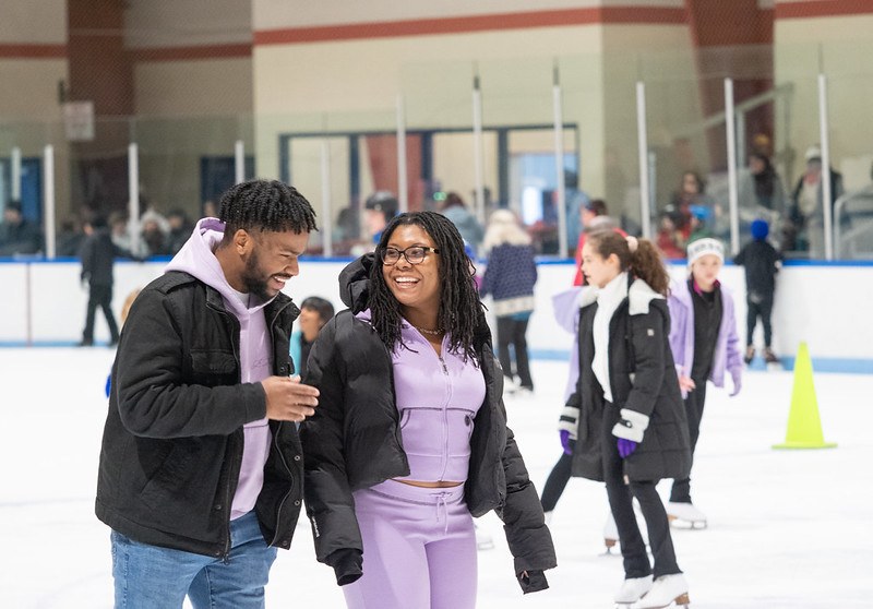People ice skating and smiling