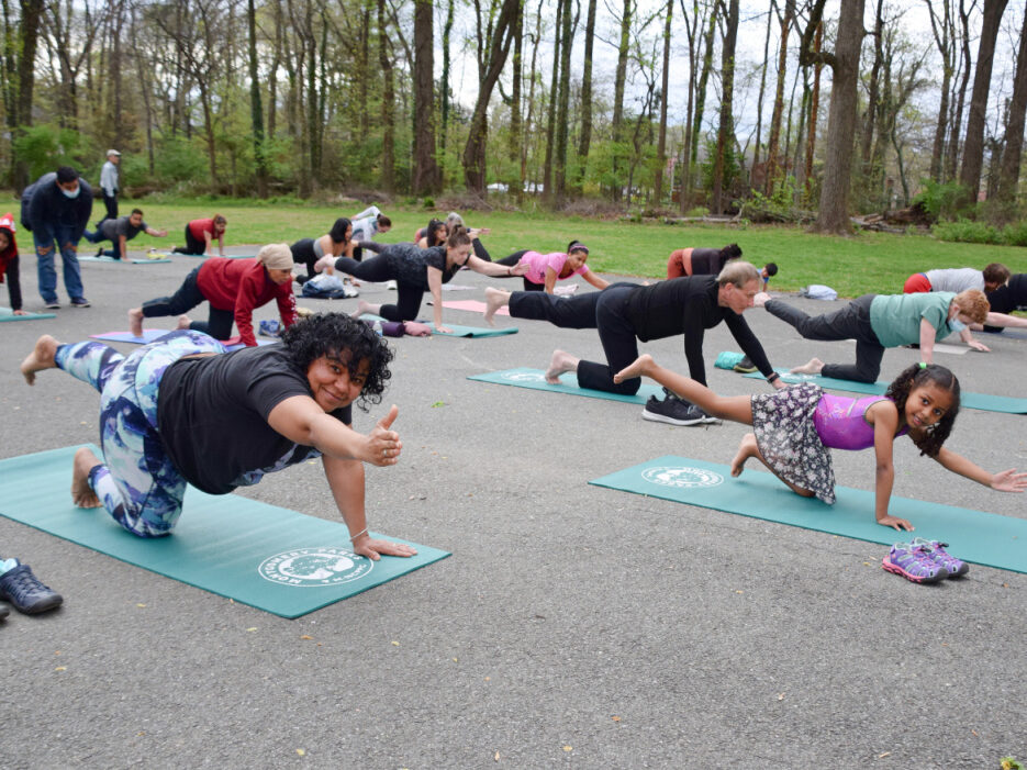 yoga class posing, outside at brookside gardens