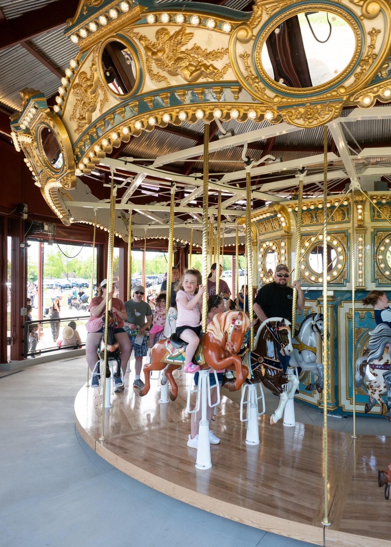 People ride the Ovid Hazen Wells Carousel