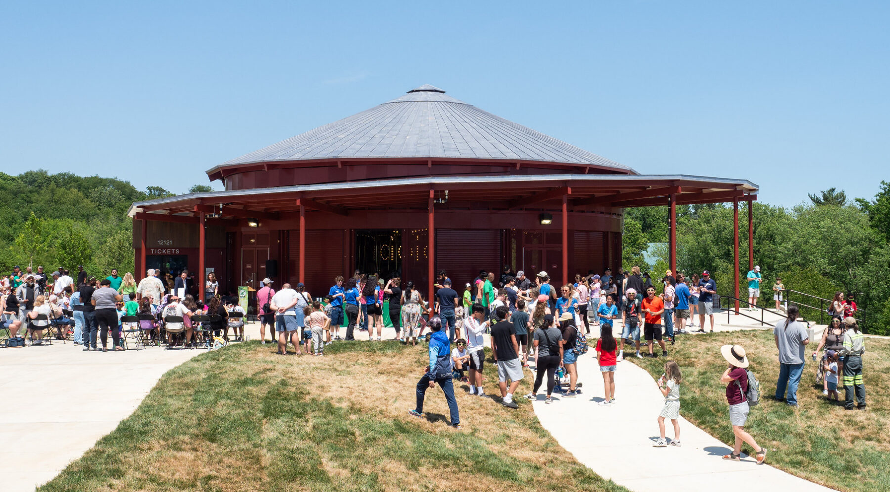 A crowed of people outside of the Ovid Hazen Wells Carousel