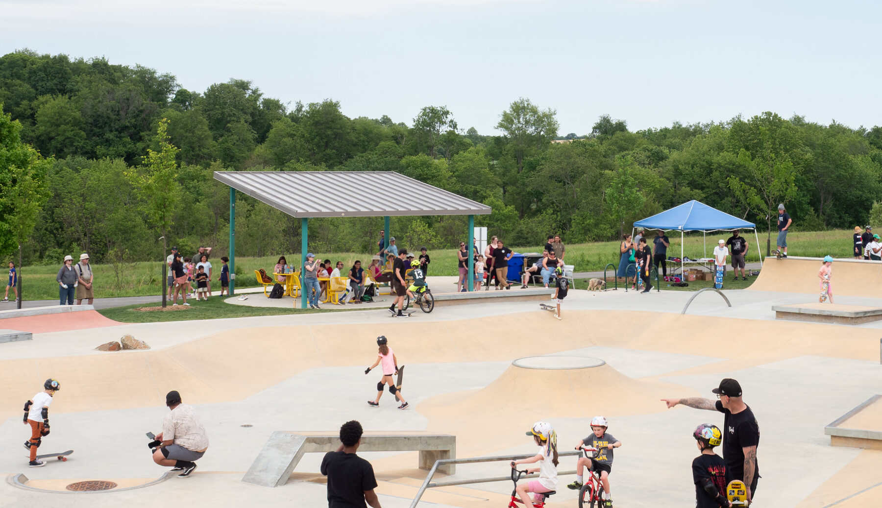 An outdoor skate park filled with people.