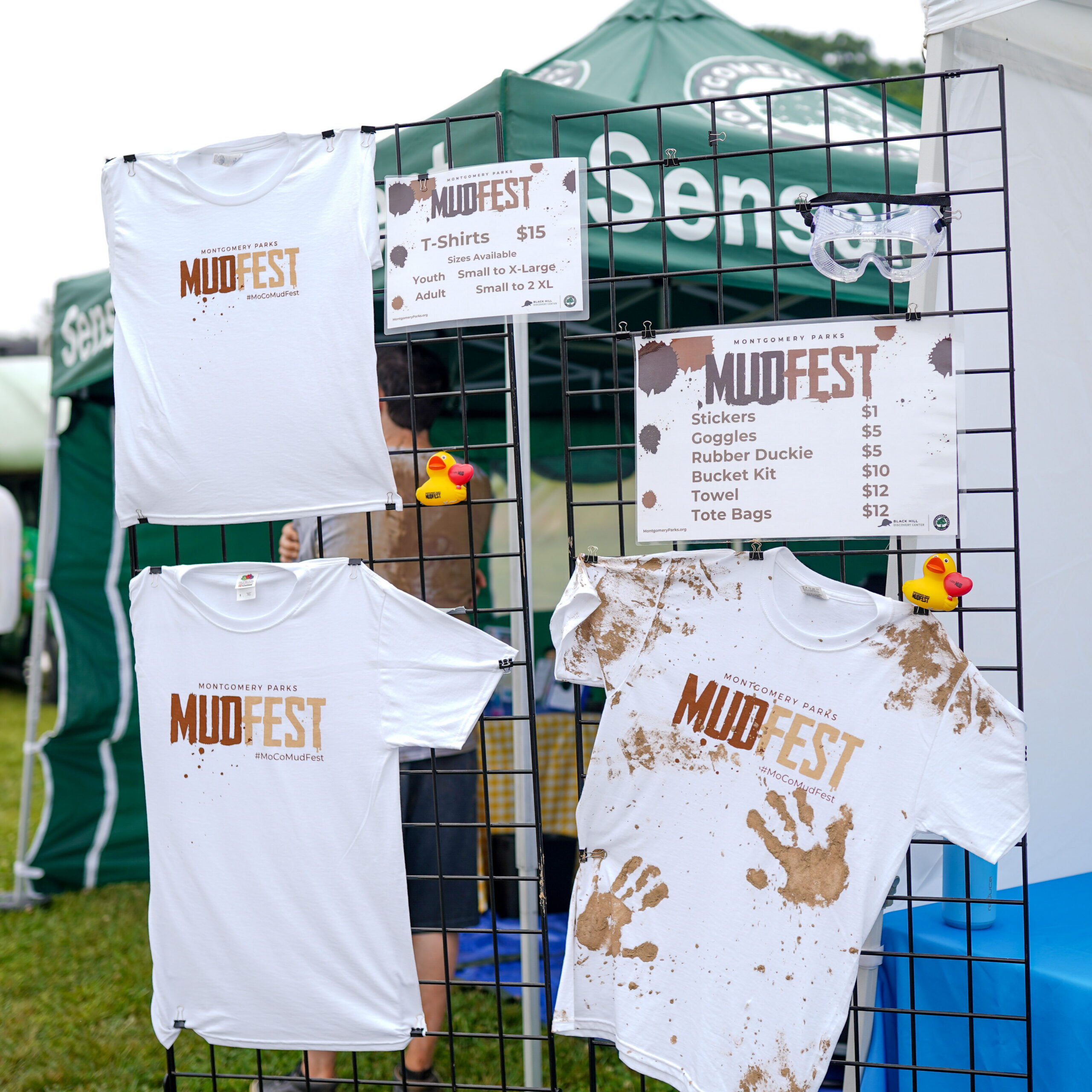 MudFest display of t-shirts and sizes.