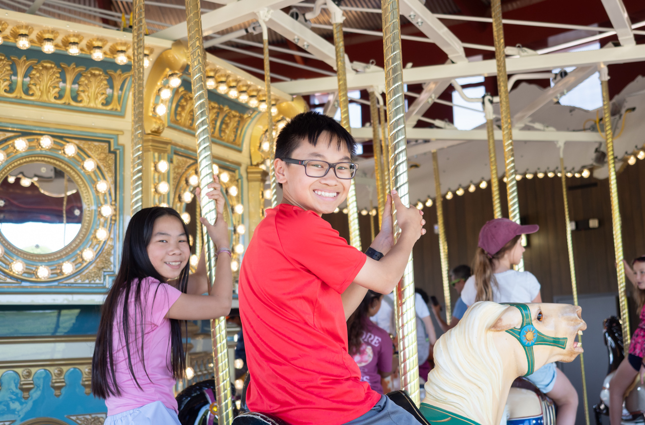 Children riding the carousel at Ovid Hazen Wells Rec Park