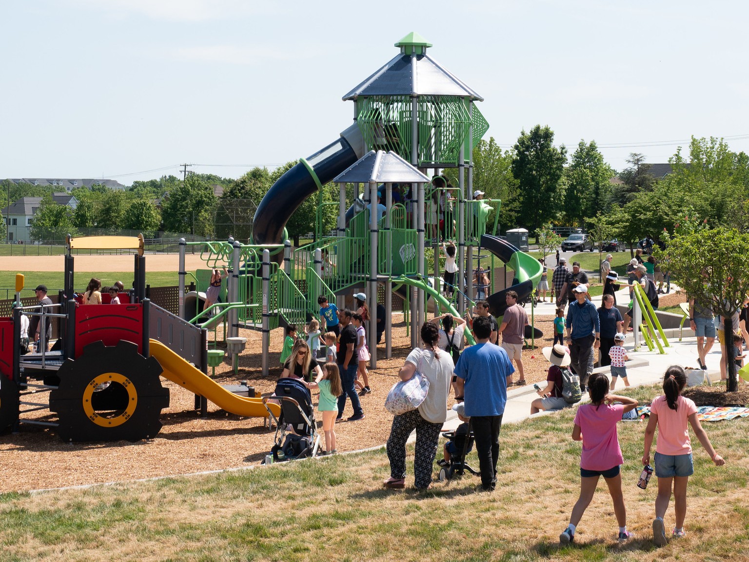 A group of people at the playground at Ovid Hazen Wells Recreational Park.