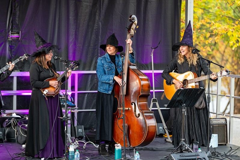 Band dresses in witch costumes on stage