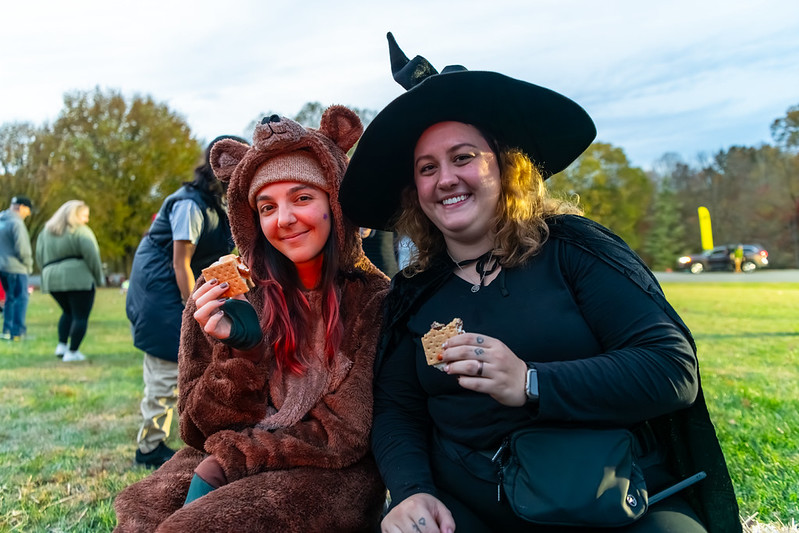 Attendees smile at camera holding smores