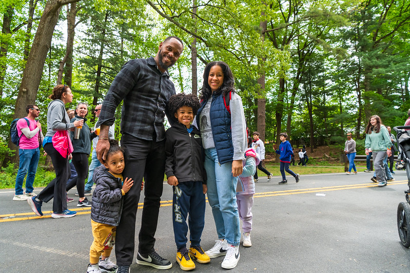 Family smiles for camera on parkway