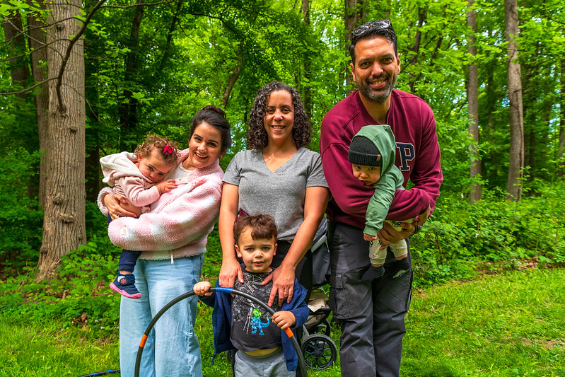 Family smiles for camera in grass