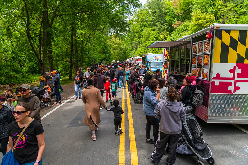 Food trucks and attendees along parkway