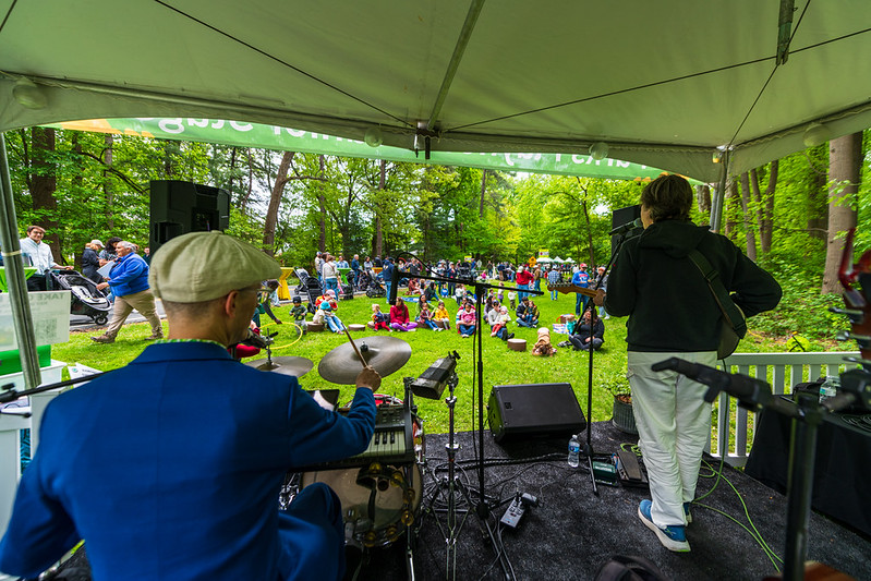 Kids band performs on stage to audience in background